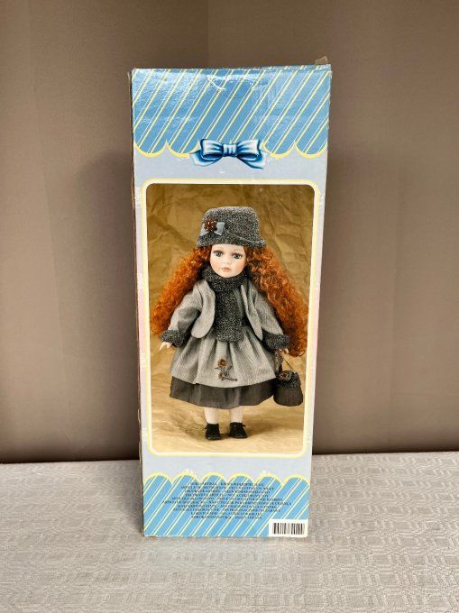 Poupée de collection, tête et membres en porcelaine, Neuve dans sa boite